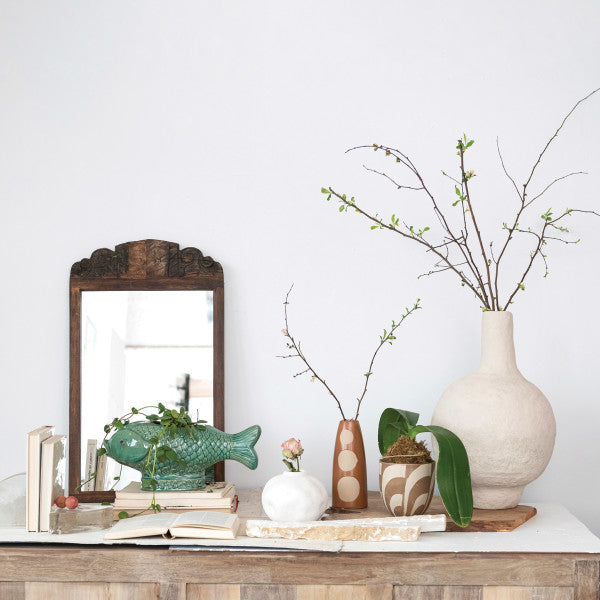 A turquoise debossed stoneware fish planter with a reactive glaze.